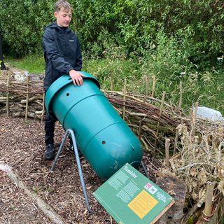 A boy holding a green jake tumbler