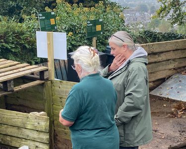 Master composter Janet, speaks with a vistor of our compost demonstration site