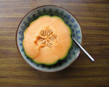Melon sliced in half in bowl
