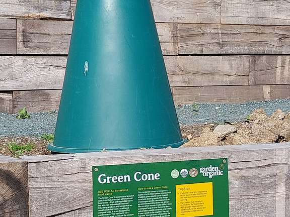 A green cone compost bin