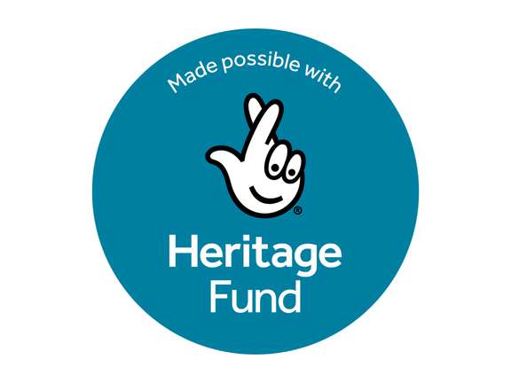 A blue circle with a white hand with it's fingers crossed in the middle. Inside the circle white the text reads "Made possible with Heritage Fund"
